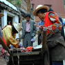 Tibetans buying meat on the street in front of Derge Publishing House.