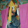 A statue of derge Monastery's protector deity in the Assembly Hall with offering scarves.