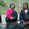 Tibetan pilgrims wearing black chubas and using rosaries at Zangdok Pelri Temple.