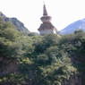 A stupa on top of a small hill.