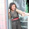 Young Tibetan girl wearing a black chuba.