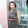 Young Tibetan girl wearing a black chuba.