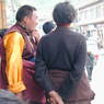 Lama talking with a Tibetan man on the street.