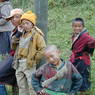 Tibetan boys pose for the photographer on the side of the road.