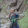 A Tibetan boy poses for the photographer on the side of the road.