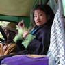 A young Tibetan girl at the wheel of a Landrover.
