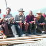 Seated Tibetan pilgrims with prayer wheels and rosaries at the Gyutrul Temple [sgyu 'phrul lha khang].