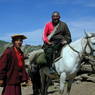 Tseko, the construction and road manager of Larung Gar religious settlement, with a Tibetan man on horseback.