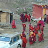 A group of monks gathered near the Assembly Hall ['du khang].