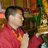 Monk Yonten Gompo holding a statue of the Buddha.