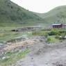 Tibetan houses near a stream.