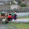 Tibetan man with horse and two children near the bridge.