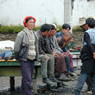 Tibetan men talking around the pool table on the street.