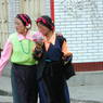 Two young nomad women walking on the street.