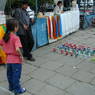 A Tibetan-American girl playing a ring game in the plaza in front of the Jokhang Temple.