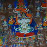 Close-up of a painted carving of the four-faced manifestation of the Buddha Vairocana.