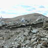 Cairns and prayer flags at the top of a pass.