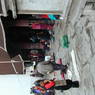 Tibetans prostrating in the courtyard before the entrance portico of the temple.