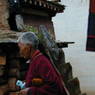 An eldery Tibetan nun circumambulating the monastery.