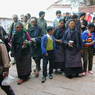 Tibetan pilgrims ascending the steps behind the palace.