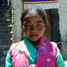 A young Tibetan girl visiting to watch the religious dance.
