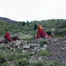 Abbot Dorji Tashi and a monk ascending a hill on horses.
