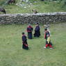 Tibetans walking to the site where the religious dances are to take place.