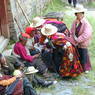 Nomads seated along a wall to watch the religious dances.