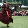 Unmasked monks dancing in the courtyard.