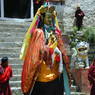 A dancer dressed as Padmasambhava in the courtyard.