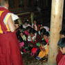 Nomad women and children prostrating before Abbot Dorji Tashi.