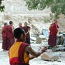 Monks debating religious topics in the debating garden or Tsenyi Academic College.