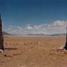 The site’s two rooted pillars. Note the sacred Bon lake Gunggyü Tso (<i>gung rgyud mtsho</i>) in the background.