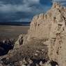 An adobe-block wall of the structure.