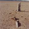 The pillar and the line of large stones before it.