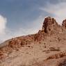 The rocky spine of the formation. The remains of the semi-subterranean dependencies and temple (lower right side) are visible on the slopes below the rocky spine.