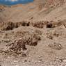 Ancient wall vestiges below a line of caves.