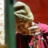 -An elderly nun with prayer wheel in rMe ru monastery