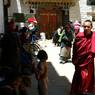 --Two monks walking outside Entrance of rMe ru monastery