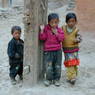 Three kids in front of Jo khang lha khang of 'Khor chags dgon pa