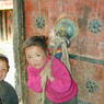 Kids playing at door of Ka brgya lha khang of 'Khor chags dgon pa