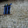 A window on the side of a house in the village of sMu pa, in Kong po