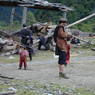 Men working in an open square in the village of sMu pa, in Kong po