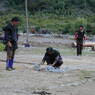 Men working in an open square in the village of sMu pa, in Kong po