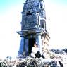 Large Malla pillar with Buddhist chaitya on top