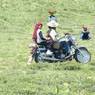 Tibetan nomad couple riding motorcycle.&nbsp;