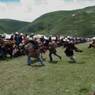 Tibetan men and women preparing to watch horse festival.
