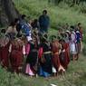 Bro participants gather near cypress tree and recites the text