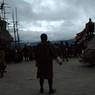 Dancers walks as they dance in speed circumambulating the statue