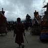 Gonpo and Gonmo chham dancing to and fro near Guru statue